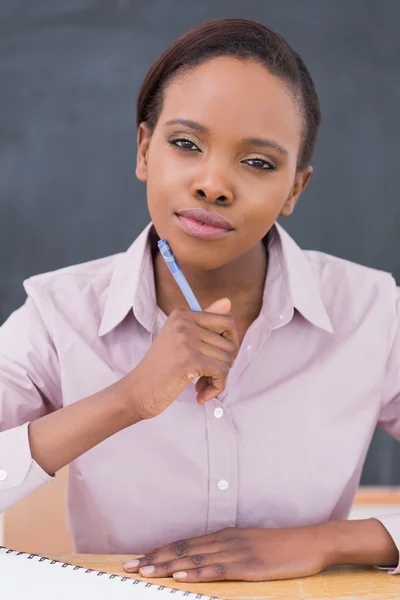 Black teacher looking at camera while thinking — Stock Photo, Image