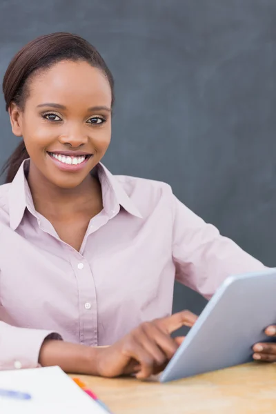 Teacher looking at camera while using a tablet computer — Stock Photo, Image