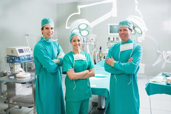 Surgeons with arms crossed smiling — Stock Photo, Image
