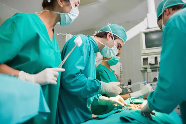 Хирург с помощью хирургического инструмента — стоковое фото