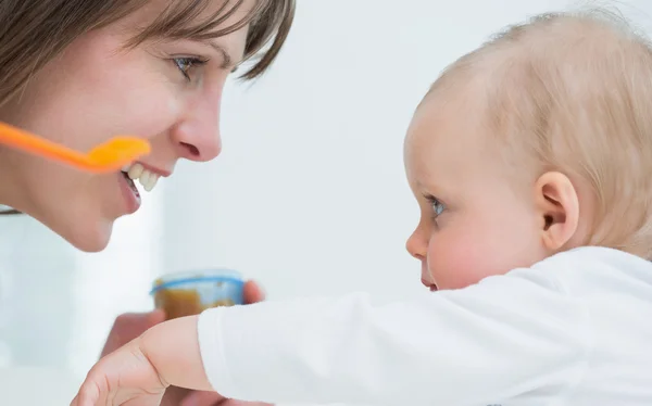 Mother face in front of a baby Royalty Free Stock Images