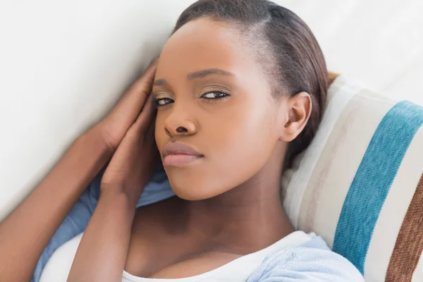 Black woman looking at camera while lying Stock Photo