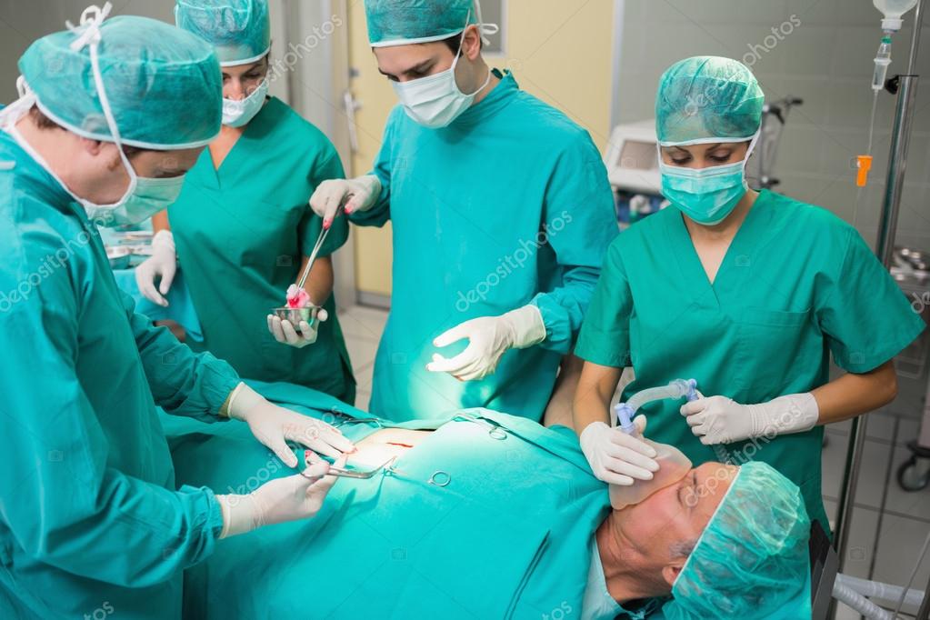 surgeon giving surgical tool to a nurse stock photo surgery nurse