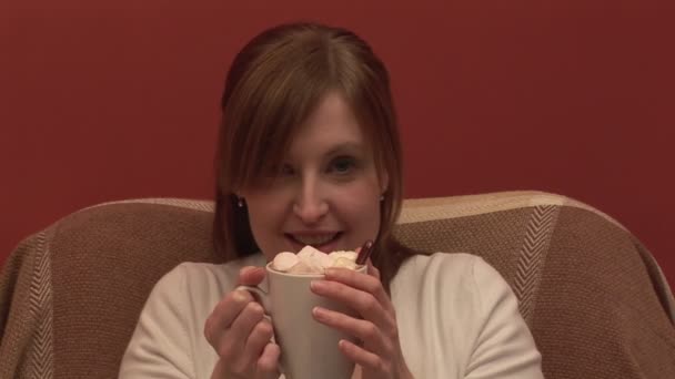 Beeldmateriaal van een vrouw op een bank drinken koffie — Stockvideo