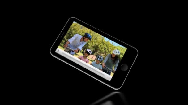 Smartphone showing families relaxing outside — Stock Video