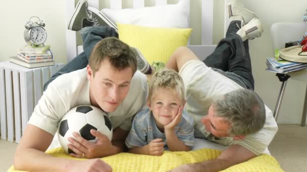 Grandfather and grandson watching football — Stock Video