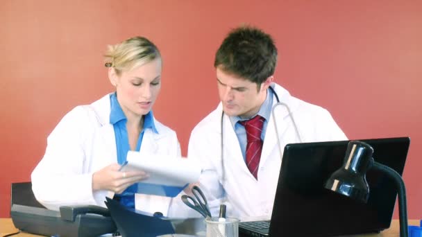 Doctors studying a patient report — Stock Video