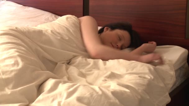 Snoozing woman looking at alarm clock — Stock Video