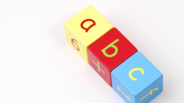 Colorful alphabet toy blocks spelling ABC turning — Stock Video