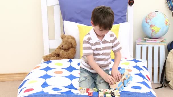 Little boy playing with a train in his bedroom — Stock Video