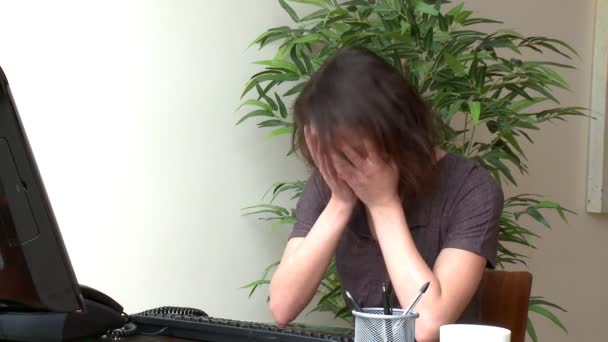 Depressed woman working at a computer — Stock Video