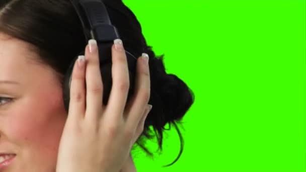 Green screen of a woman listening to music — Stock Video