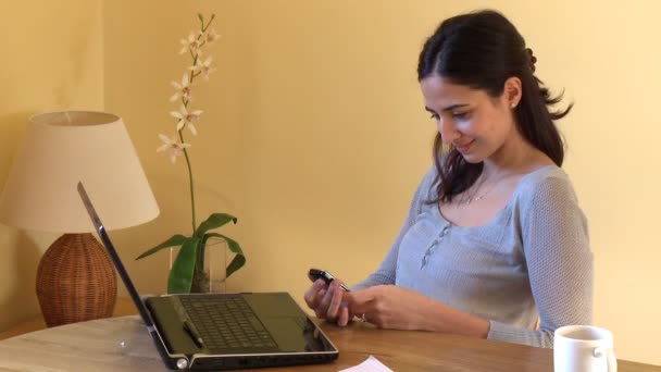 Positive woman at computer sending a text message — Stock Video