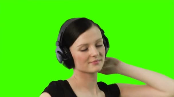 Green screen of a woman listening to music — Stock Video