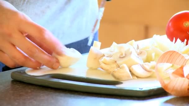 Close-up of a woman cutting mushrooms — Stock Video