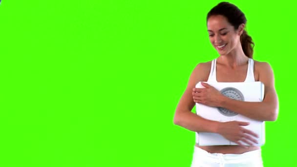 Attractive woman holding a scale — Stock Video