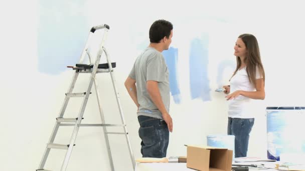 Woman kissing and hugging her husband during a renovation — Stock Video