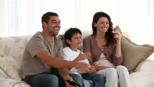 Famiglia guardando la televisione sul divano — Video Stock