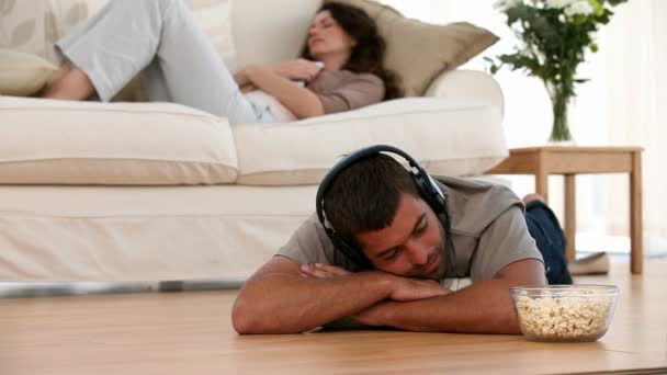 Hombre en casa escuchando música en el suelo — Vídeo de stock