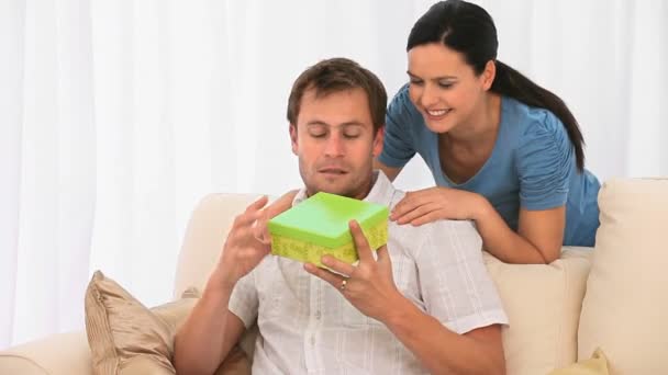 Woman offering a gift to her husband — Stock Video