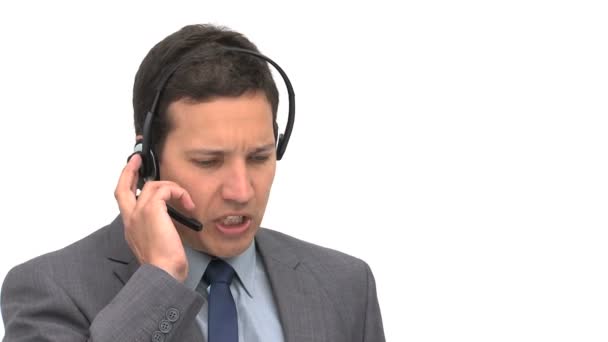 Angry businessman on the phone with earpiece — Stock Video