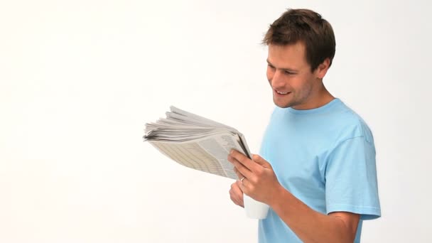 Smiling man reading a newspaper — Stock Video