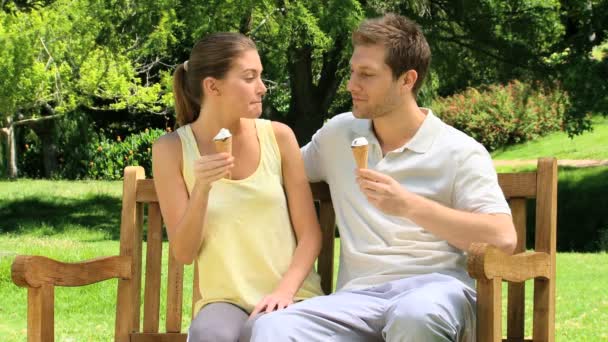 Happy couple enjoying their ice creams — Stock Video