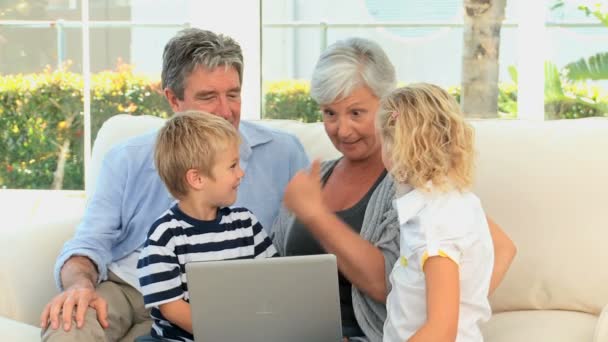 Family in front of a computer talking — Stock Video