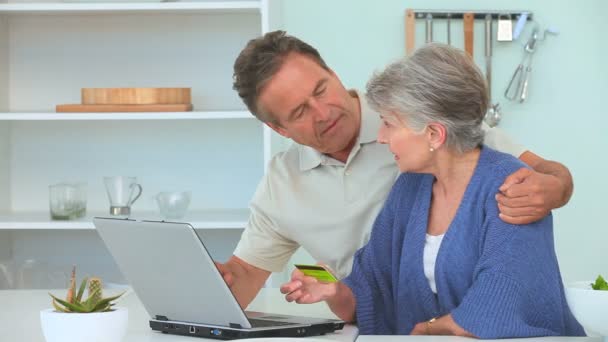 Mature couple using a credit card — Stock Video