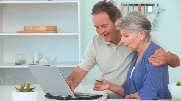 Mature couple using a laptop — Stock Video