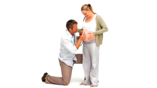 Man listening through the belly of his pregnant wife — Stock Video