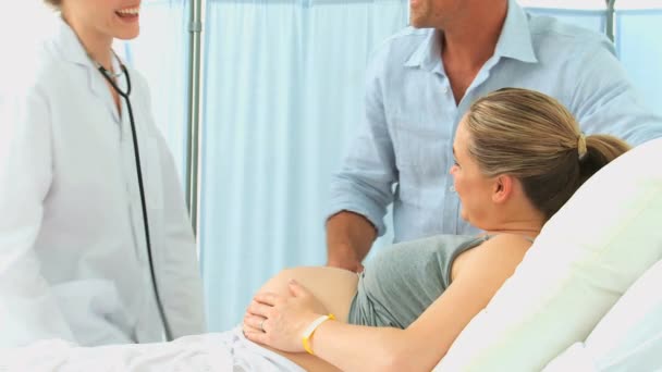 Linda enfermera examinando el vientre — Vídeos de Stock