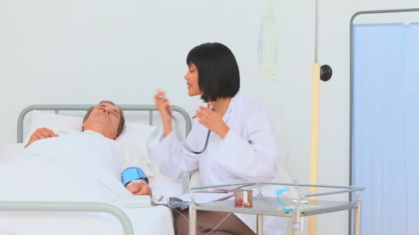 Asian nurse taking the blood pressure — Stock Video