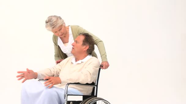 Un hombre en silla de ruedas recibiendo un masaje de su esposa — Vídeos de Stock