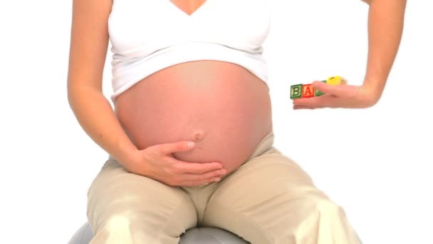 Pregnant woman holding building blocks — Stock Video