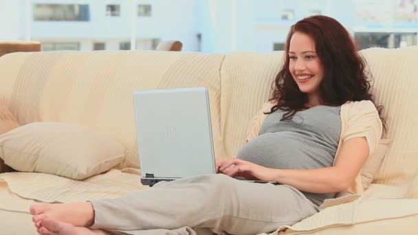 Pregnant lady chatting on a laptop — Stock Video