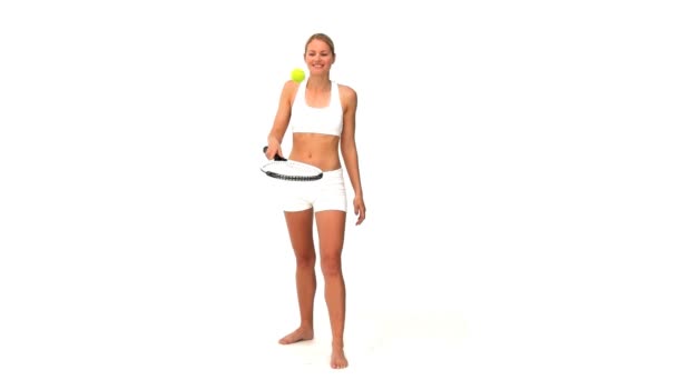 Woman in sporswear with a racket and tennis ball — Stock Video