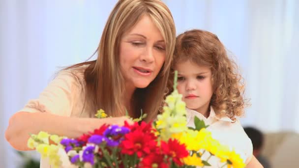 Mormor tittar på en massa blommor — Stockvideo