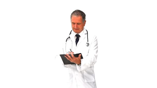 Elderly doctor taking notes — Stock Video