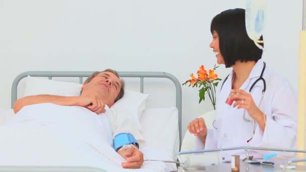 Asian nurse taking the blood pressure of her patient — Stock Video