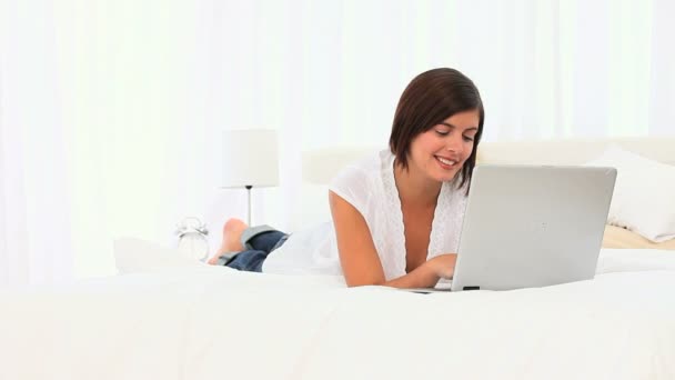 Cute brown-haired woman using her laptop — Stock Video