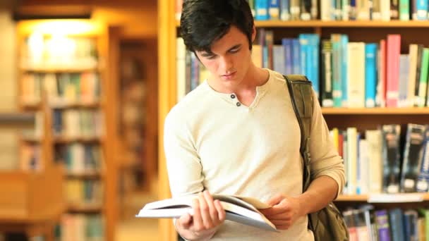 Young man reading a book — Stock Video