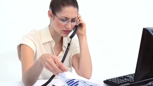 Serious woman on the phone looking files — Stock Video