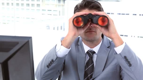 Businessman looking through binoculars — Stock Video