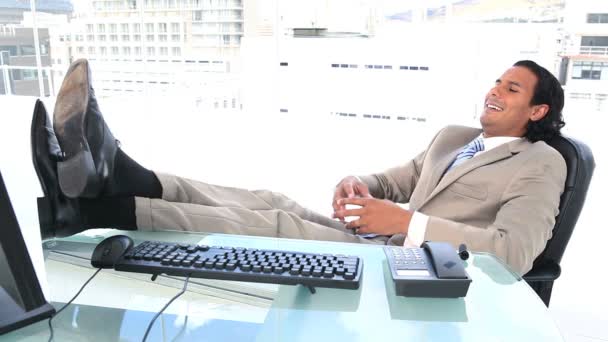 Latin businessman resting in his office — Stock Video