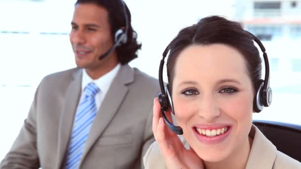 Smiling in suit using headsets — Stock Video