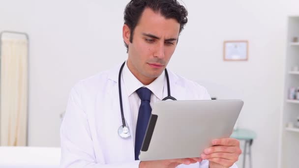 Serious doctor using a touchscreen — Stock Video