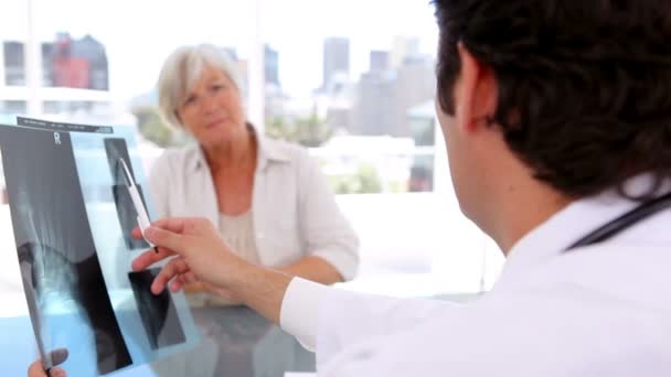 Serious patient listening to her practitioner — Stock Video