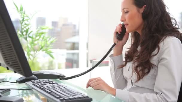 Businesswoman answering the telephone — Stock Video
