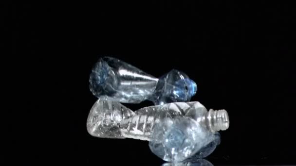 Three plastic bottles in a super slow motion falling — Stock Video